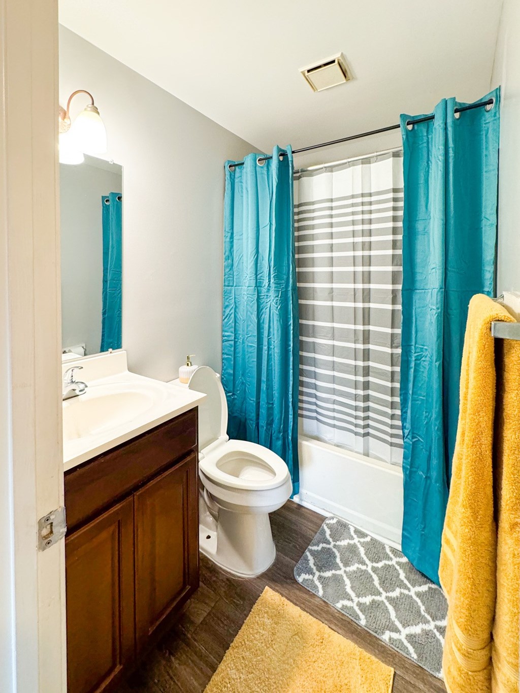 a bathroom with a toilet and a shower and a sink